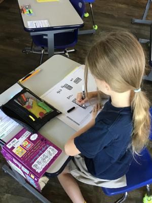 a young girl uses graphing in math