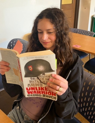 a girl reading a book in a classroom