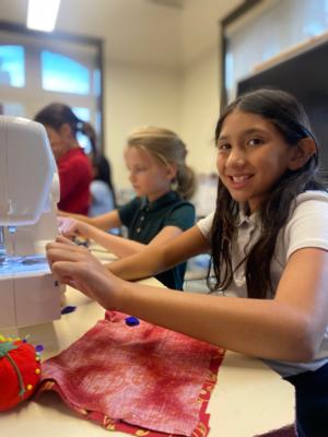 two girls at sewing club at St. Elizabeth's School