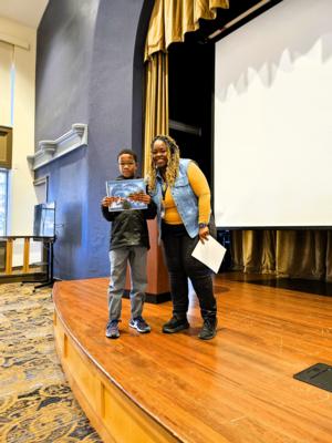 A student receives a character award at St. Elizabeth's school